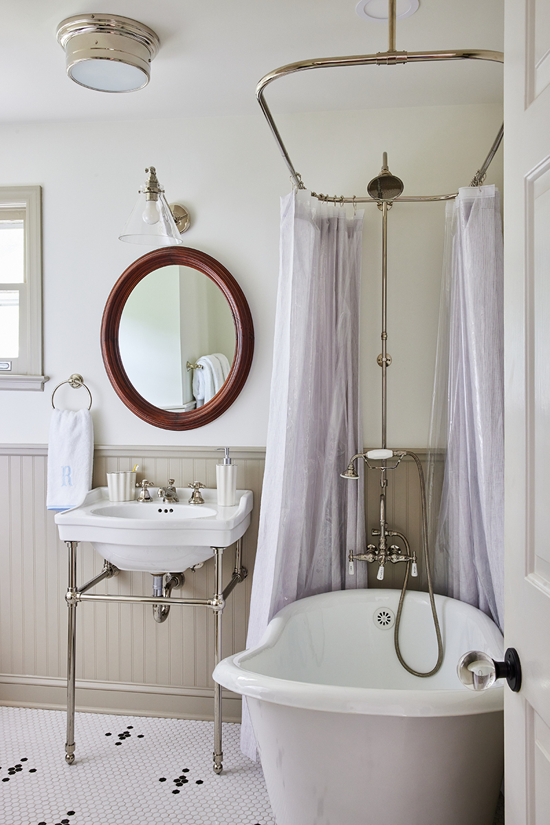 classic interior design bathroom for carly riordan by jennifer muirhead interiors featuring signature hardware cierra console sink, weezie towels signature starter pack in light blue, and signature hardware erica cast iron clawfoot slipper tub