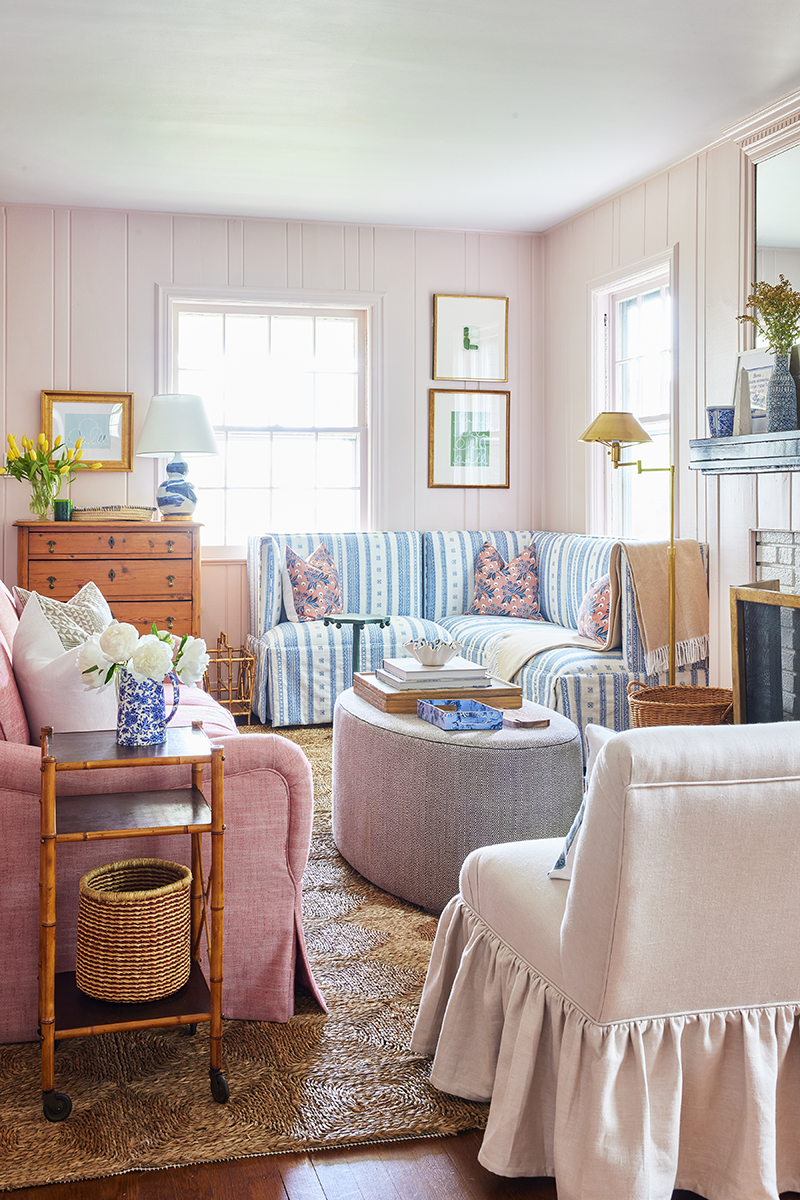 grandmillennial style living room for carly riordan by jennifer muirhead interiors featuring calamine by farrow and ball, henriette in terracotta pillows, kayce hughes art, tory burch spongeware pitcher, and rush house original rug