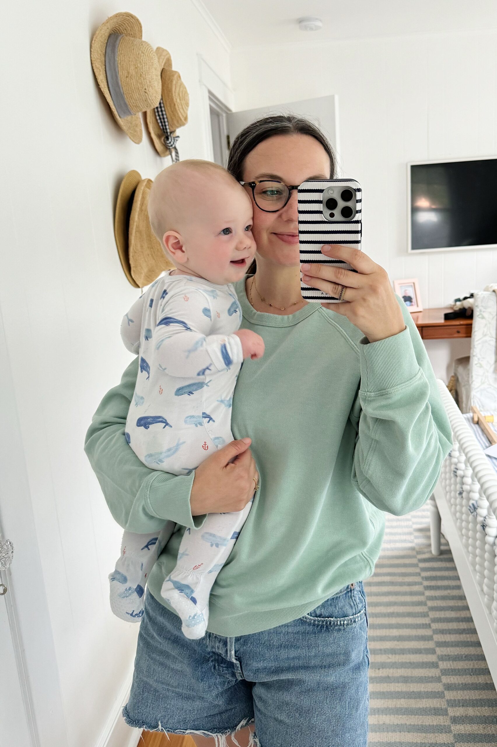 A mirror selfie of Carly holding Rory 