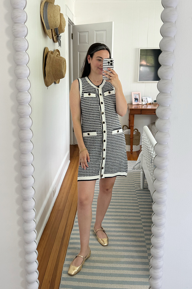 A mirror selfie of Carly wearing a knit dress. 