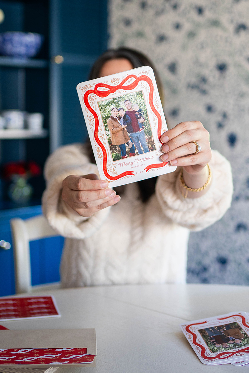 Carly holding up her holiday card from Shutterfly