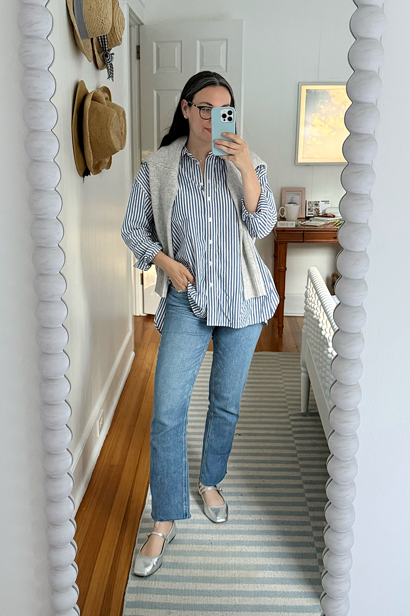 Carly Riordan in a mirror selfie wearing a button down and metallic mary janes.