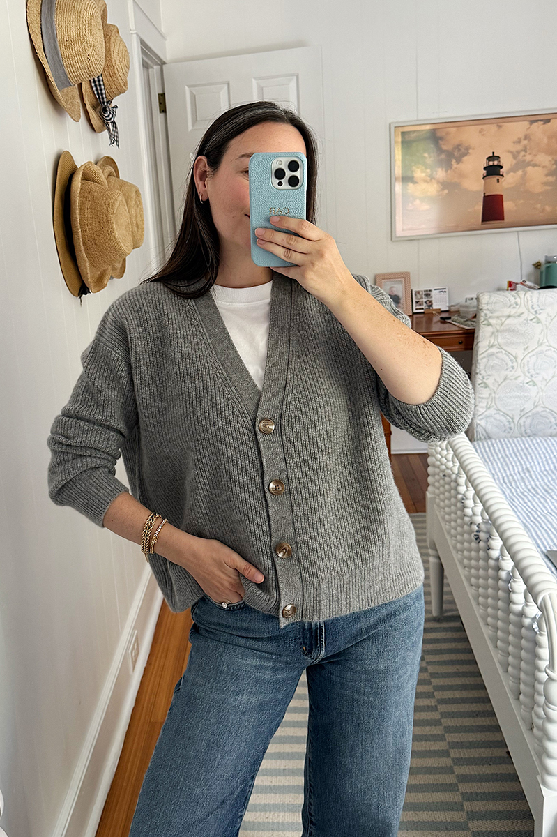 Carly Riordan wearing a Quince grey cashmere cardigan sweater for a Quince clothing review.