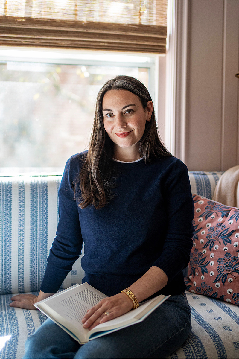 Carly Riordan wearing a Quince navy cashmere crewneck sweater.