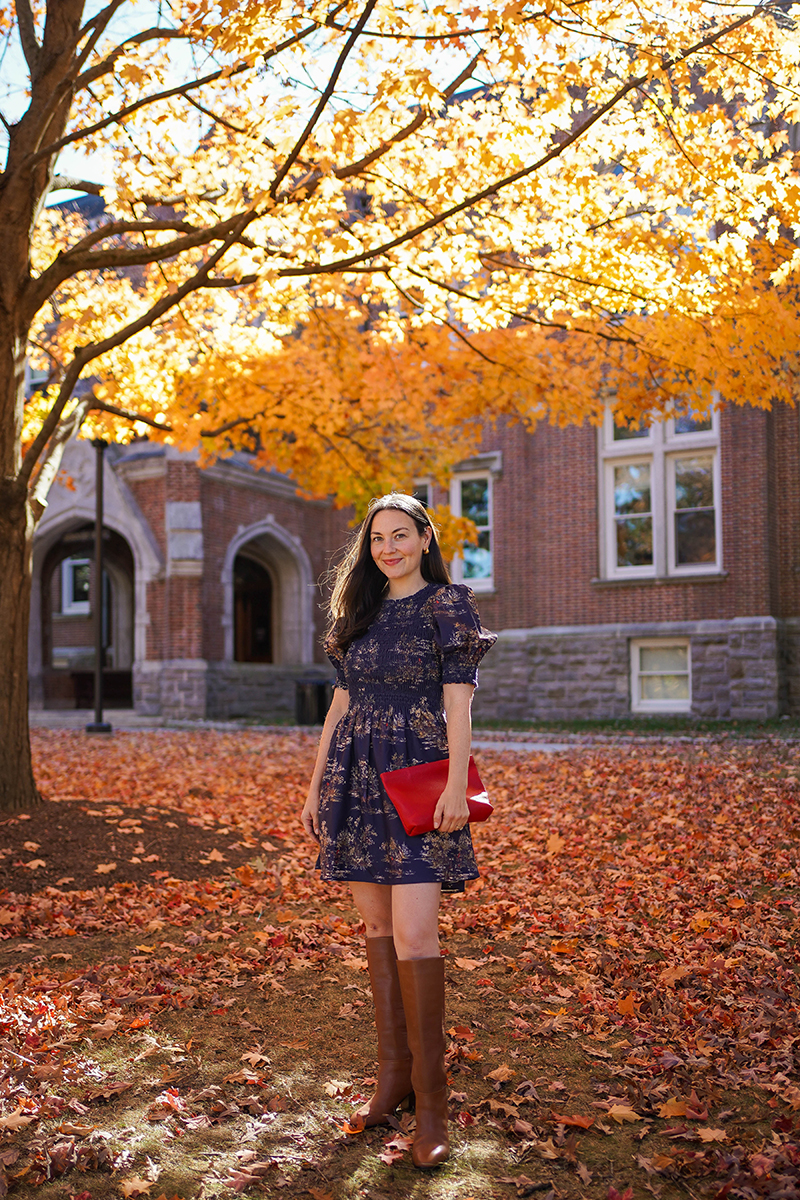 Carly Riordan wearing a Vivi nap dress with a fall toile print and tall boots.