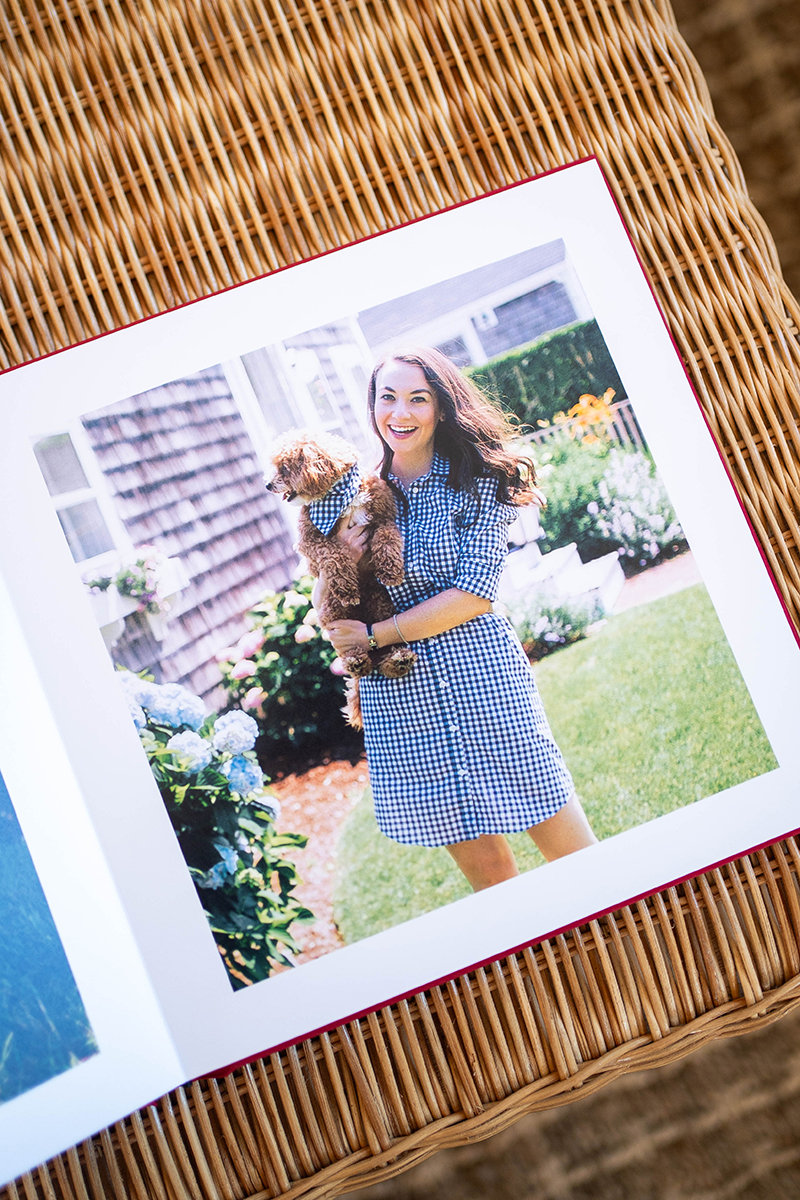 An open photo album of Carly holding her late dog Hamilton